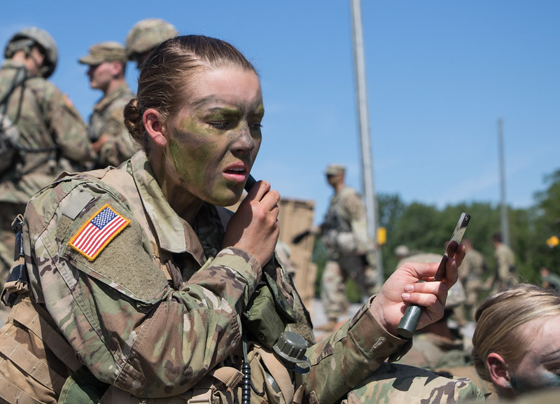 Female Army ROTC Cadet applies camouflage